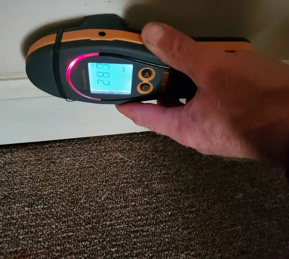 Moisture detection at baseboard during Storm Damage Restoration in Harvard
